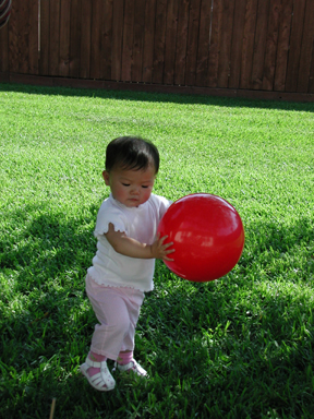 Outside with my red ball! Fun!