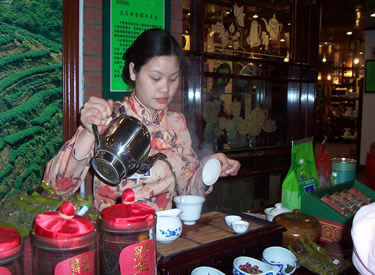 Waitress serves samples of Chinese Tea to us!